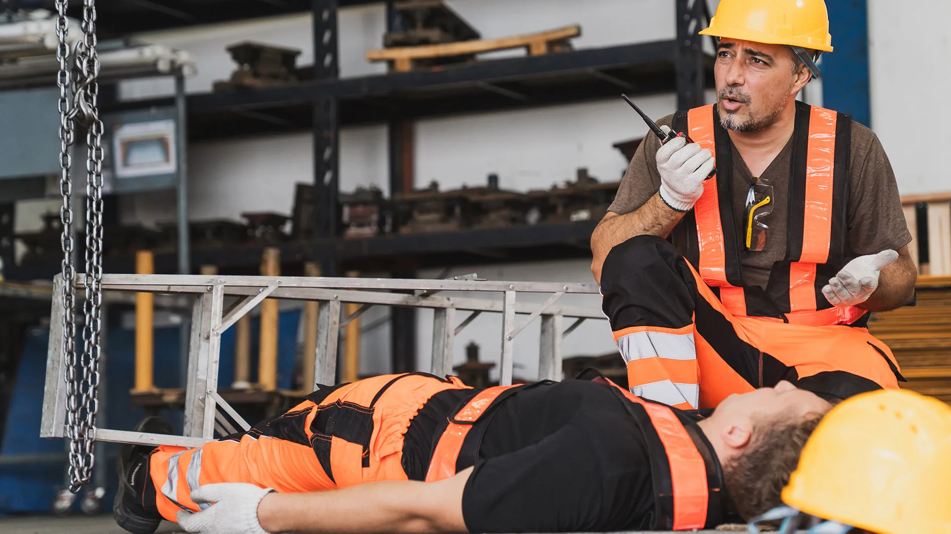 Two workers in high-visibility vests at a jobsite beside an Injury Care Associates van, as a clinician steps out through its open side door.