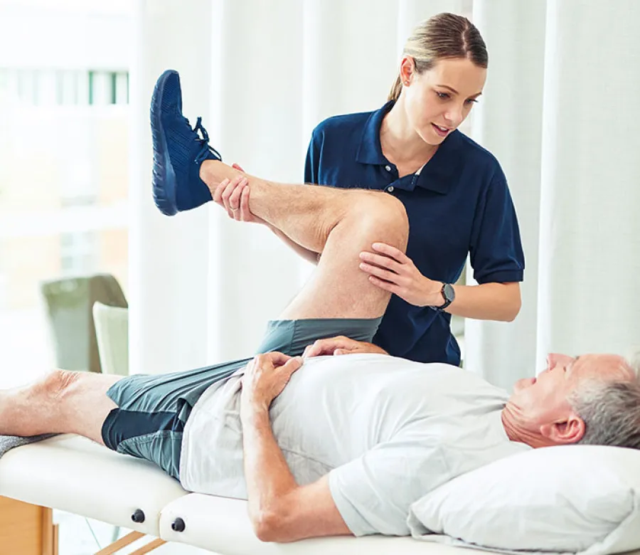 ICA physical therapist guiding a patient through a shoulder exercise