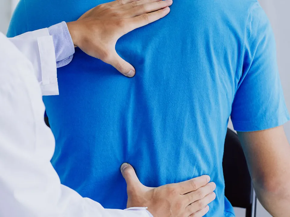 ICA clinician measuring a patient’s shoulder motion with a goniometer