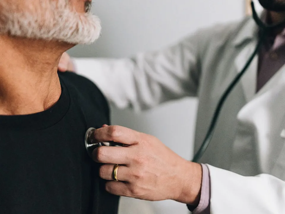 ICA clinician taking an employee’s blood pressure at a workplace screening event