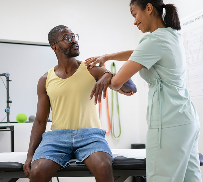 Provider reviewing a job description with an employee during a fitness-for-duty exam